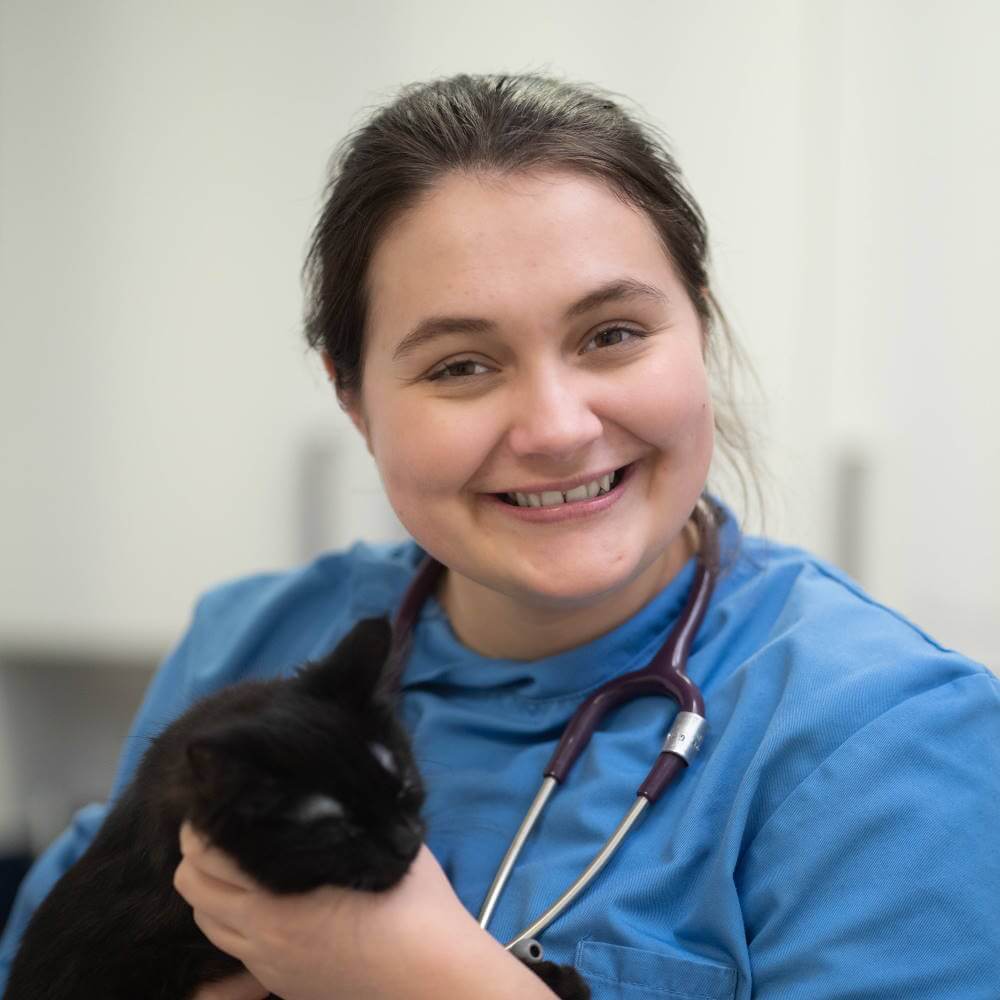 Rebecca holding a black cat